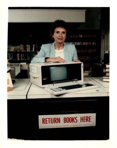 Nancy Jacobson with automated circulation terminal, 1980