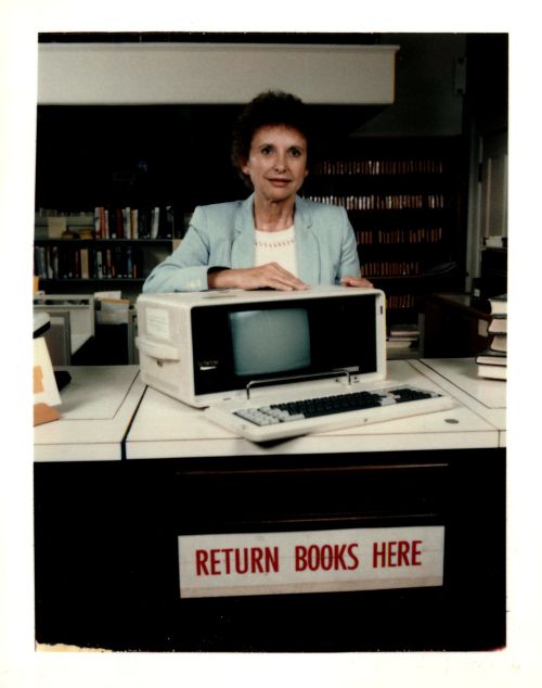 Nancy Jacobson with automated circulation terminal, 1980